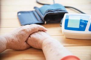 Old lady is being checked blood pressure using blood pressure monitor kid set - people with health care medical instrument set concept photo