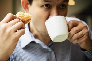 Business man eat the American breakfast set in a hotel - people take a breakfast in hotel concept photo