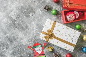 Top view of Gift boxes with Christmas decoration on gray grunge background. photo