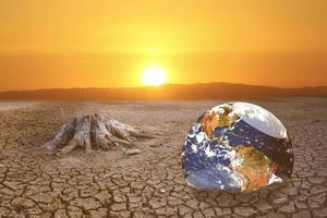 The concept of global warming and drought and poverty and food shortages. Arid soils with hot climates have a globe that lacks green space. photo