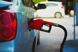 Gas station nozzles. Cars that are refueling in the gas station. The concept of fuel prices has changed. photo