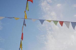 Festive colorful flags in the blue sky photo