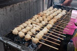 selective focus on grilled meatballs skewered with bamboo and sold at culinary festivals photo