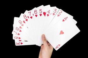 Hand holding Playing cards isolated on black background. photo