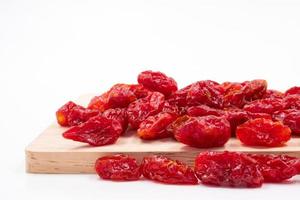 Dried Tomatoes on wooden tray. photo