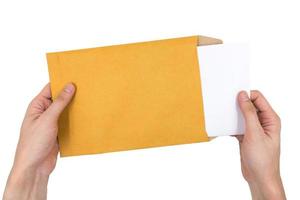 Hands holding envelope with document isolated on white background. photo