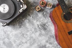 Top view of Vintage Turntable with Guitar and cactus on grunge background, Free space for text photo