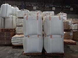 Large jumbo hemp sack White, packed with chemical fertilizer, rice, sugar, placed on a wooden pallet waiting to be delivered to the customer photo