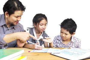 Daddy teaching his kids during doing homework photo