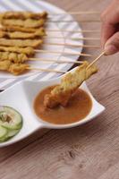 Pork satay,Grilled pork served with peanut sauce or sweet and sour sauce, Thai Street food. photo