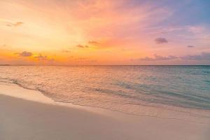 Closeup sea sand beach. Panoramic beach landscape. Inspire tropical beach seascape horizon. Orange and golden sunset sky calmness tranquil relaxing sunlight summer mood. Vacation travel holiday banner photo