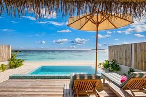 Fantastic over water villa, terrace view with sun beds chairs under umbrella, luxury pool hotel with stunning ocean view. Beautiful spa or wellness concept, recreational vacation resort tranquil area photo