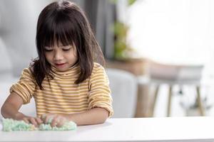 Kid play with handgum. Slime in children hands. photo