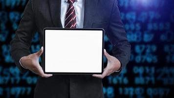 Business man holding and shows touch screen tablet with digital device, technology photo