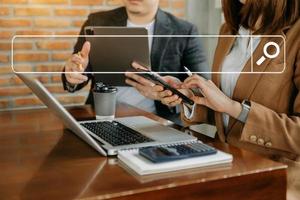 Business  team analyzing financial statement Finance task. with smart phone and laptop and  tablet. Wealth management concept at office photo