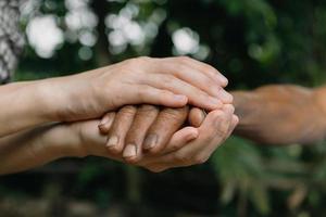 Hands of the old man and a man hand photo