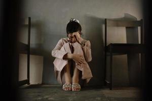 Asian woman sit Depression Standing by window and anxiety Copy space. photo