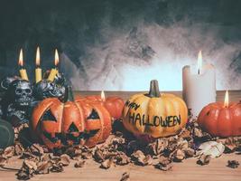 calabazas de halloween con velas y calaveras sobre fondo oscuro.
