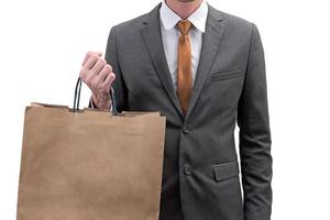 Businessman holding a shopping bag  isolated on white background. photo