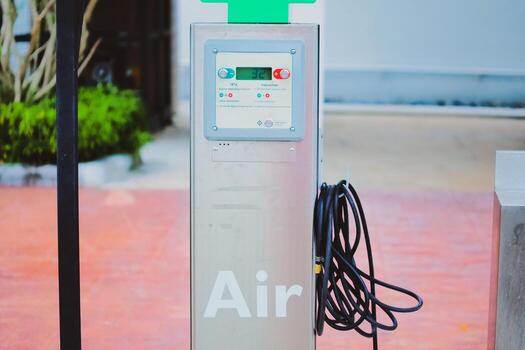 An automatic tire inflator is available at the gas station. inflator in gas station photo