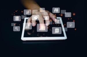 Business man use tablet for big data analysis and business intelligence marketing planning concept virtual screen. photo