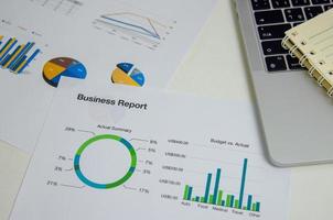 Top view document graph business finance investment marketing with computer laptop on desk. photo