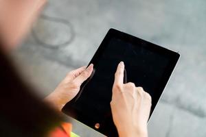 Businessman checking inventory in stock room of a manufacturing company on touchscreen tablet photo