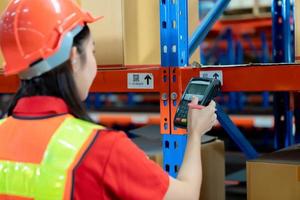 Closeup shot of worker scanning  barcode reader. Reading and Scanning labels on the boxes with bluetooth barcode scanner in a warehouse. photo