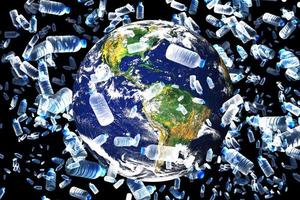 The concept of plastic waste overflowing the world. A globe with only plastic waste plastic water bottle photo