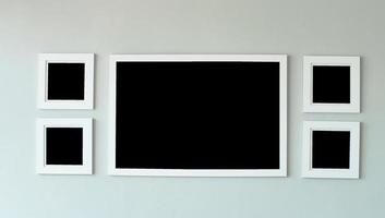 White picture frame on concrete wall with copyspace for inserting desired content. photo
