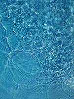 Defocus blurred blue water shining in the sea. rippled water detail background. The water surface in the sea, ocean background. Water wave under sea texture background. photo