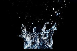 Abstract background of Water splashing on a black background. idea for freshness photo