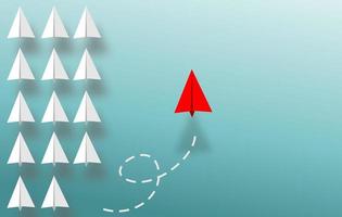 white paper plane in one direction and one red paper plane pointing in different way on blue background. Business for innovative solution concept photo