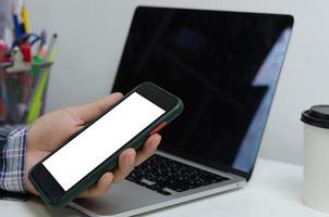 Hand man holding mobile smartphone mock up blank white screen technology online internet digital advertising business concept. photo