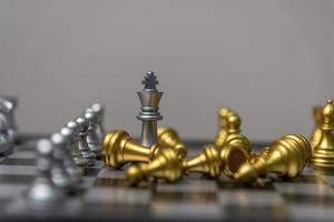 silver and gold chess on the board.Business investment finance marketing planning concept. photo