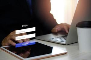 man using login interface on touch screen. user name and password inputs on virtual digital tablet account online. photo