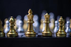 silver and gold chess on the board.Business investment finance marketing planning concept. photo