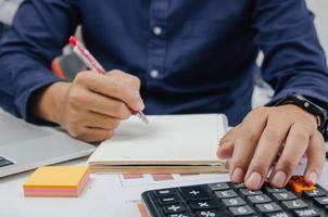 Business document finance report and accounting analysis graph.Businessman using calculate marketing investment chart paperwork statistic on desk. photo