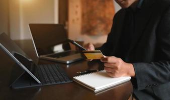 Manhands using smartphone and holding credit card with digital layer effect diagram as Online shopping concept photo