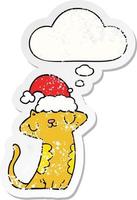 cute cartoon cat wearing christmas hat and thought bubble as a distressed worn sticker vector