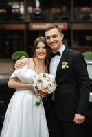 young couple bride and groom in a white short dress photo