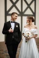 young couple bride and groom in a white short dress photo