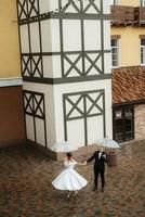 young couple bride and groom in a white short dress photo