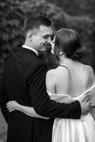 young couple bride and groom in a white short dress photo