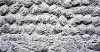 Grey stone grain bubble pattern wall spray painted textured and scratched concrete background in retro style with copy space photo