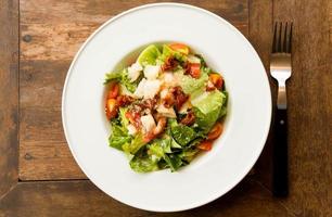 cesar salad in white plate photo