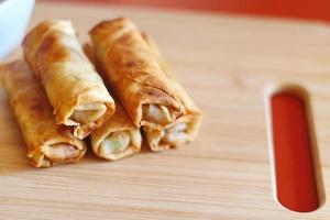 Spring rolls with chili sauce on the wooden background photo