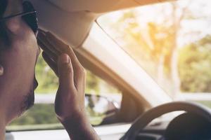 Sleepy yawning man driving a car photo