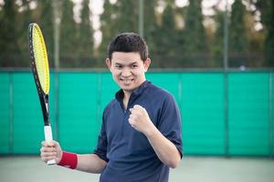 Tennis player expresses his victory in the game - people in tennis match concept photo