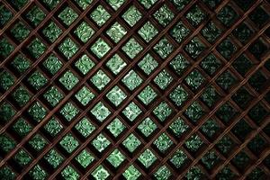 green stained glass window with wooden grid photo